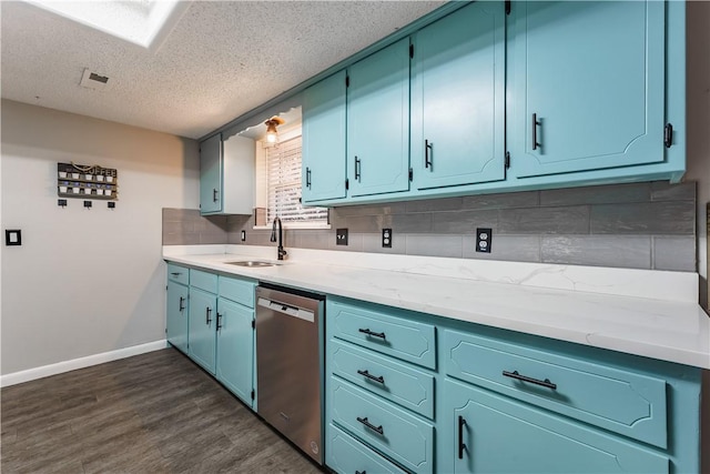 kitchen featuring dark wood-style floors, a sink, decorative backsplash, light countertops, and stainless steel dishwasher