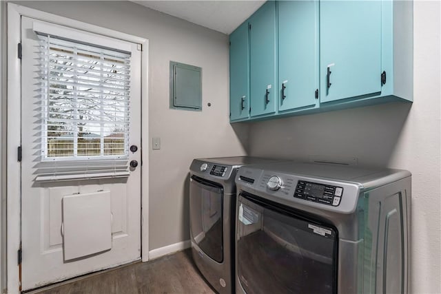 laundry area featuring baseboards, cabinet space, dark wood-style flooring, and washer and clothes dryer