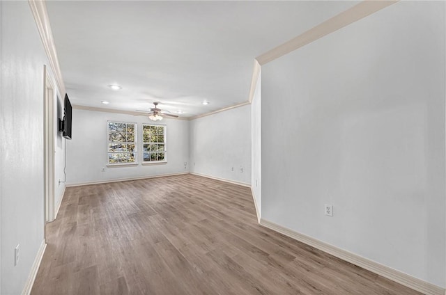 unfurnished living room with ceiling fan, ornamental molding, and light hardwood / wood-style flooring