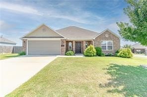 single story home featuring a garage and a front yard