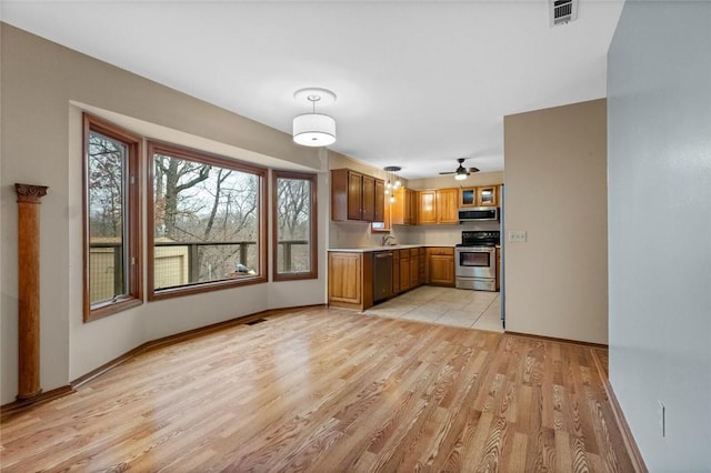 kitchen featuring stainless steel appliances and light hardwood / wood-style floors