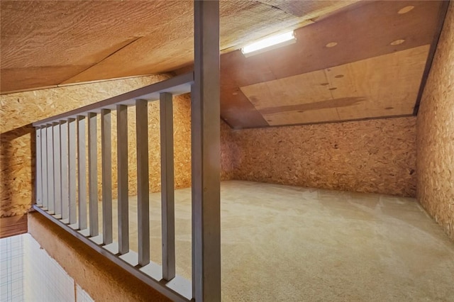 bonus room with lofted ceiling and carpet flooring