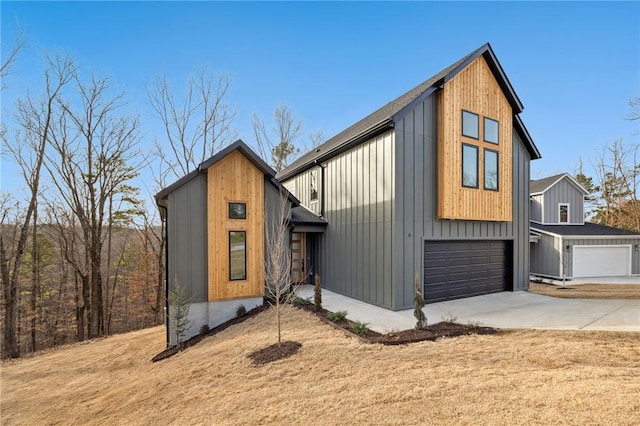 view of front facade featuring driveway, a garage, and board and batten siding