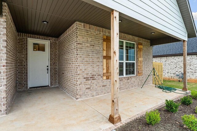1815 Bugg St, Pea Ridge, AR 72751 - property entrance with brick siding and a patio