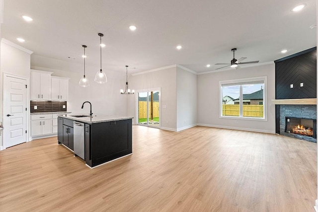 1815 Bugg St, Pea Ridge, AR 72751 - kitchen with open floor plan, a sink, stainless steel dishwasher, a ceiling fan, and ornamental molding