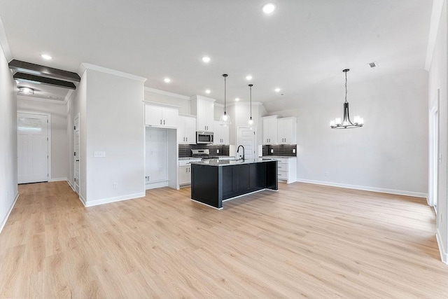 1815 Bugg St, Pea Ridge, AR 72751 - kitchen with appliances with stainless steel finishes, a sink, baseboards, a chandelier, and recessed lighting