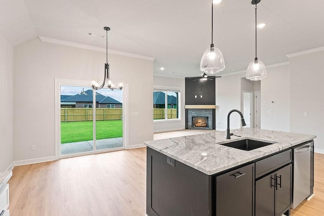 1815 Bugg St, Pea Ridge, AR 72751 - kitchen with a sink, a fireplace, ornamental molding, light wood finished floors, and a chandelier