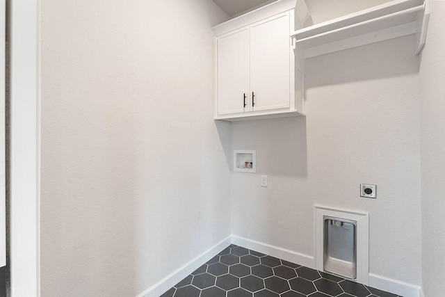 1815 Bugg St, Pea Ridge, AR 72751 - washroom featuring hookup for an electric dryer, hookup for a washing machine, cabinet space, dark tile patterned floors, and baseboards