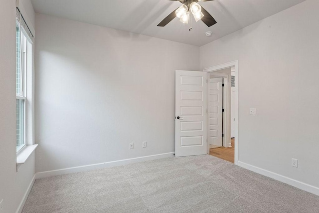 1815 Bugg St, Pea Ridge, AR 72751 - spare room featuring ceiling fan, light carpet, and baseboards
