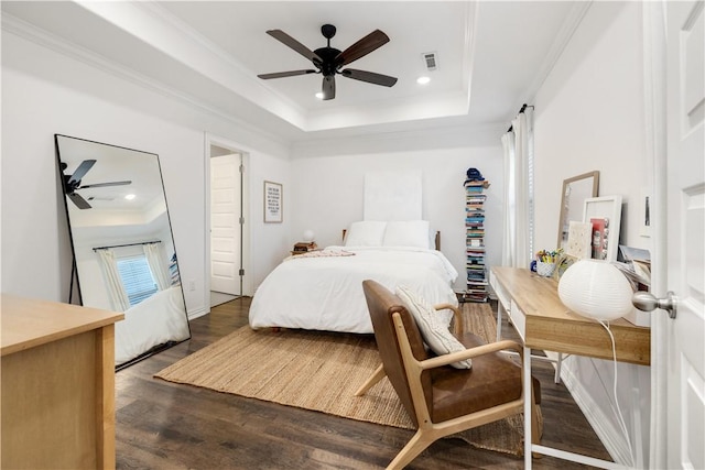 bedroom featuring ceiling fan, ornamental molding, dark hardwood / wood-style floors, and a raised ceiling