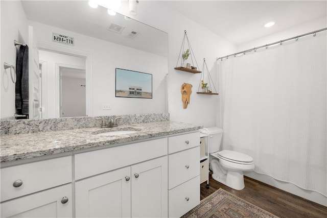 bathroom featuring vanity, toilet, and hardwood / wood-style floors