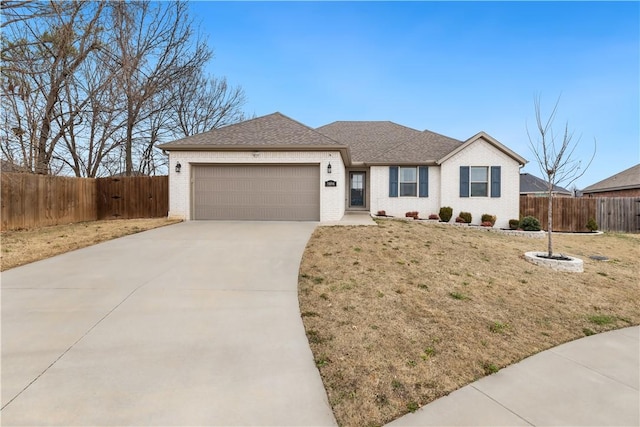 view of front of property featuring a garage and a front lawn