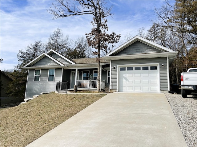 view of front of home featuring a garage, a porch, and a front yard