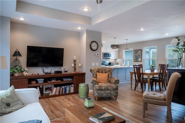 living room with recessed lighting and light wood-type flooring