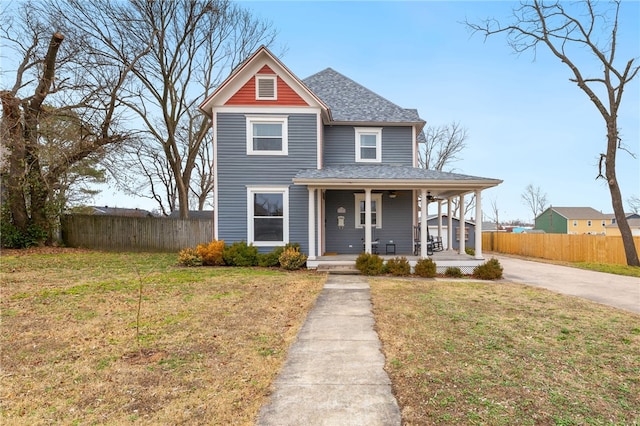 view of front of property with a front yard and covered porch