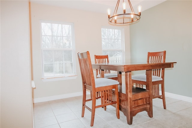 tiled dining area featuring an inviting chandelier