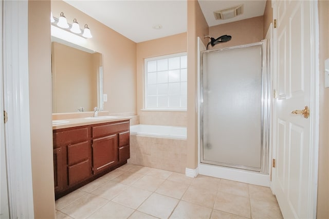 bathroom with vanity, plus walk in shower, and tile patterned flooring