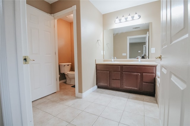 bathroom with vanity, tile patterned floors, and toilet