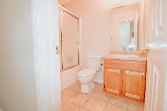 full bathroom featuring tile patterned flooring, vanity, shower / bath combination with glass door, and toilet