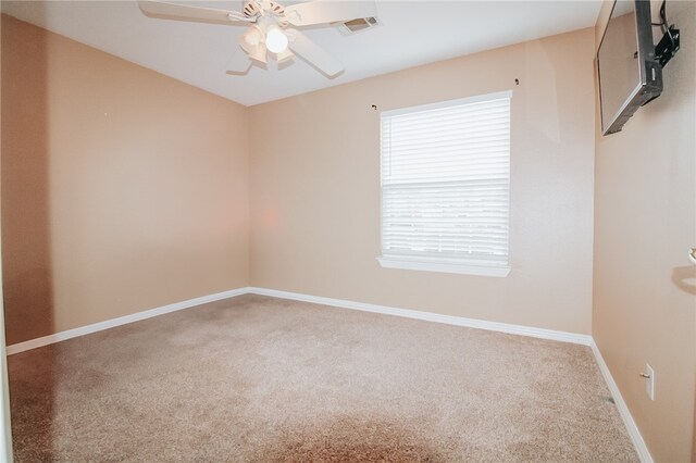 unfurnished room with ceiling fan and carpet flooring