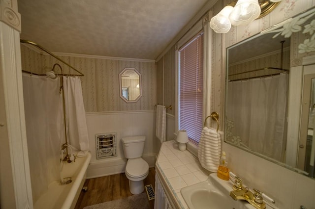 full bathroom with toilet, heating unit, crown molding, wood-type flooring, and vanity