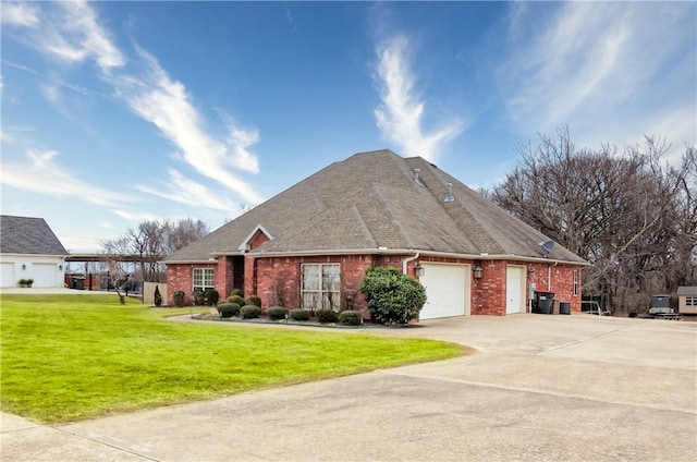 view of front of house with a garage and a front lawn