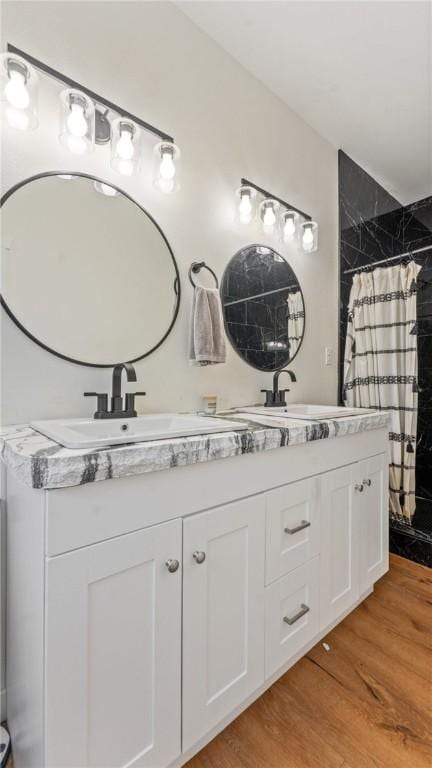 bathroom with vanity, hardwood / wood-style floors, and a shower with curtain