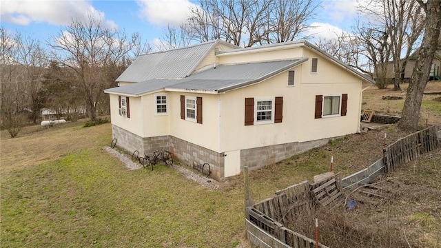 view of home's exterior with a lawn