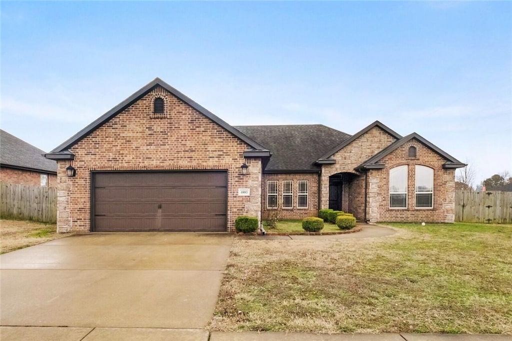 view of front of property featuring a garage and a front lawn