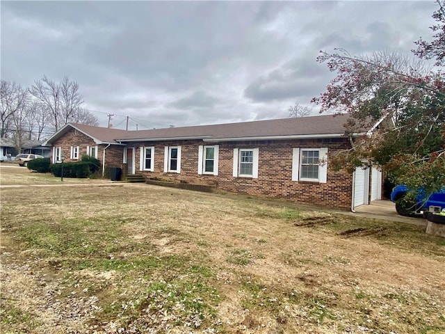 single story home with a garage and a front lawn