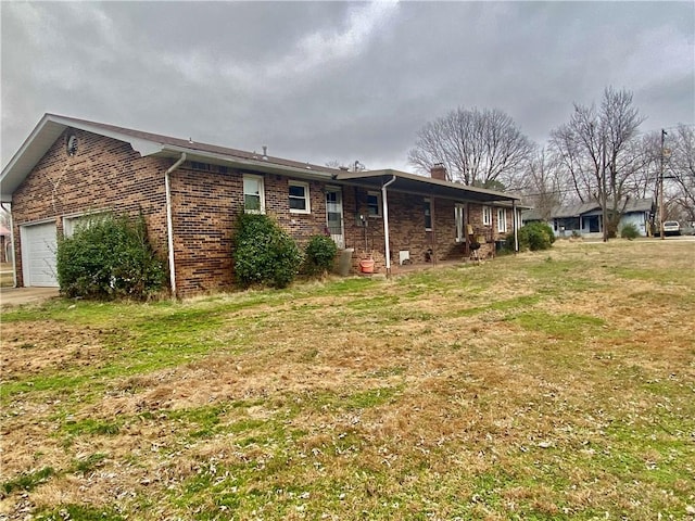 exterior space with a garage and a yard