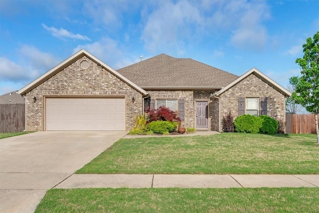 ranch-style house with fence, a front yard, brick siding, concrete driveway, and an attached garage