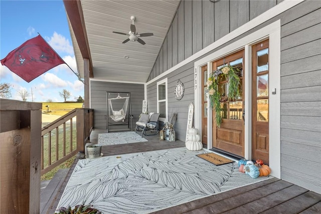 wooden terrace with a porch and ceiling fan