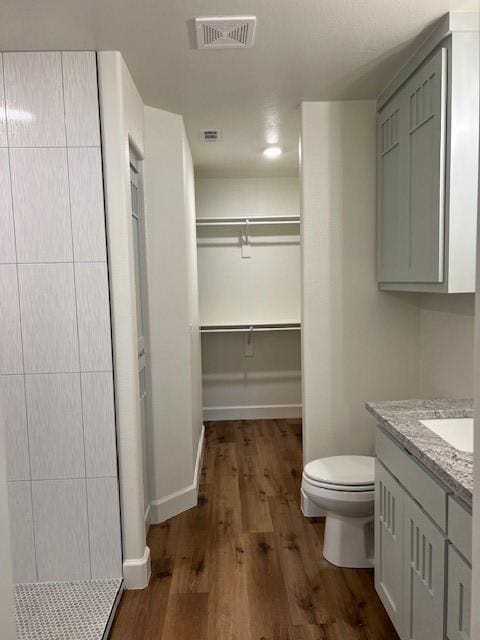 bathroom with vanity, hardwood / wood-style flooring, and toilet