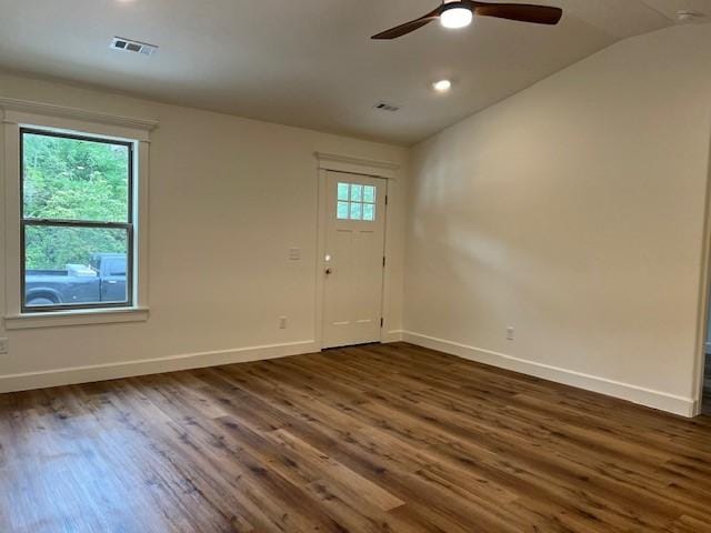 interior space featuring vaulted ceiling, a healthy amount of sunlight, ceiling fan, and dark hardwood / wood-style flooring