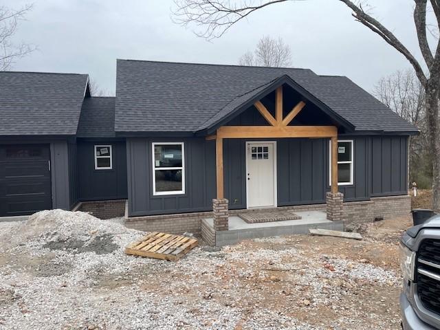 view of front of house featuring a garage and covered porch