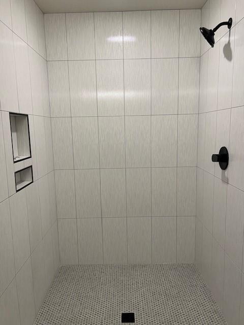 bathroom with a tile shower