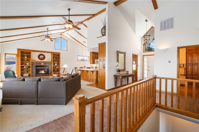 21330 Ridgeview Dr, Garfield, AR 72732 - living room with high vaulted ceiling, ceiling fan, beamed ceiling, a high end fireplace, and tile patterned flooring