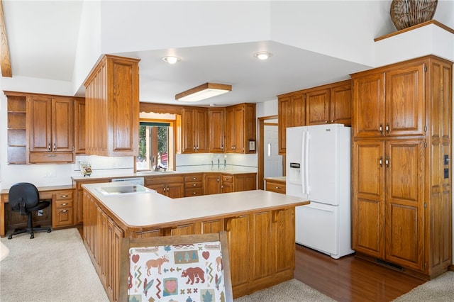 kitchen featuring white fridge with ice dispenser, brown cabinets, light countertops, and a kitchen island