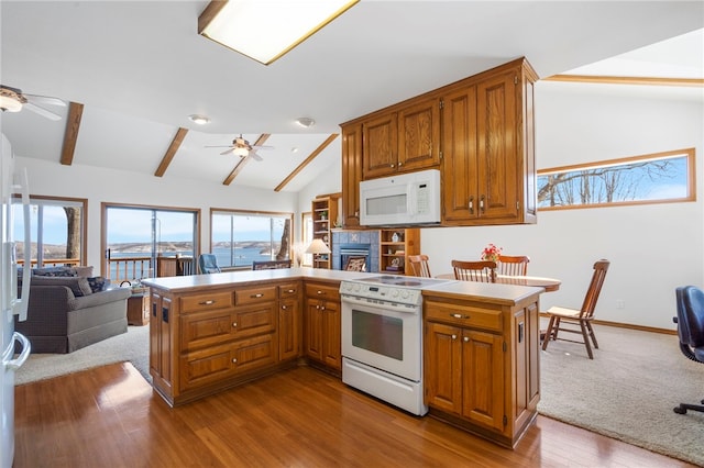 21330 Ridgeview Dr, Garfield, AR 72732 - kitchen featuring white appliances, a ceiling fan, open floor plan, and a fireplace