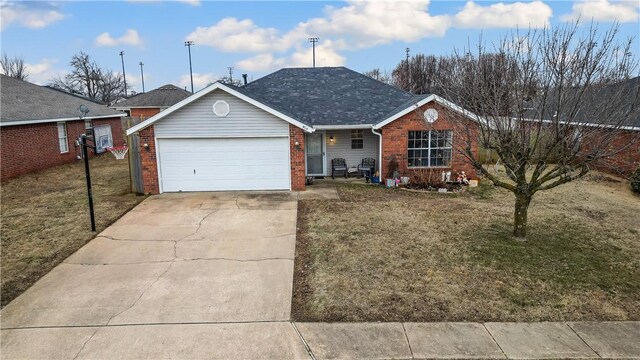 single story home with a garage and a front lawn