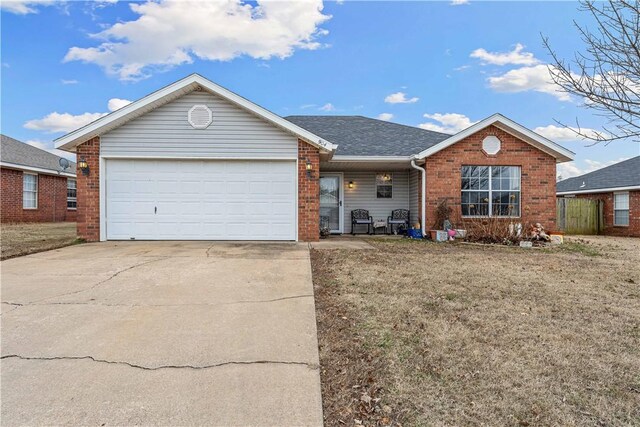 ranch-style house featuring a garage and a front lawn