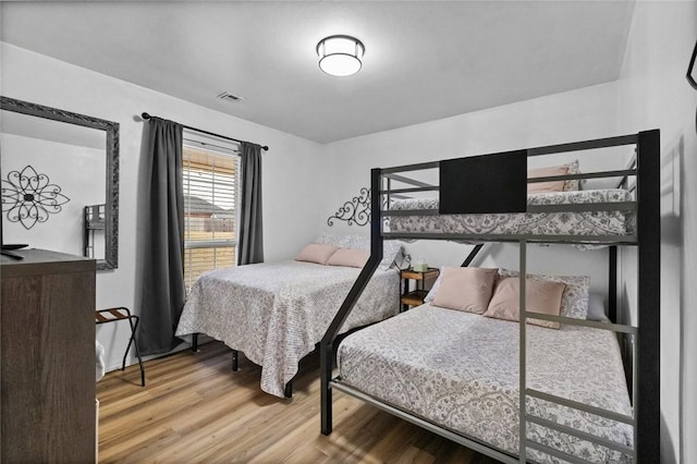 bedroom with hardwood / wood-style floors