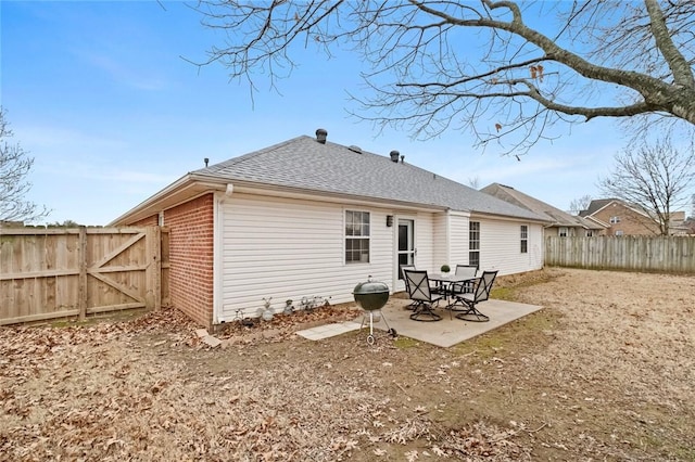 back of property with a patio