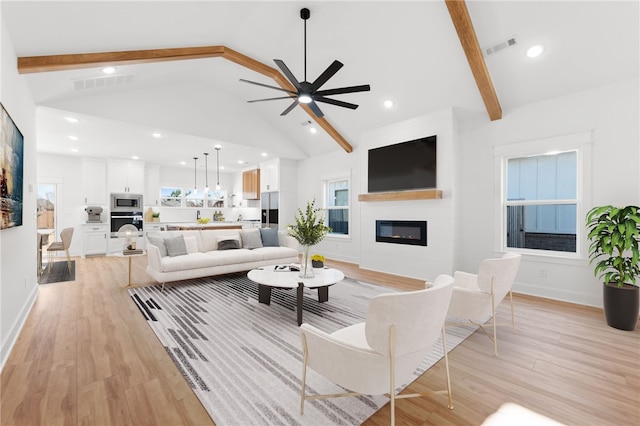 living room featuring beamed ceiling, ceiling fan, high vaulted ceiling, and light hardwood / wood-style floors