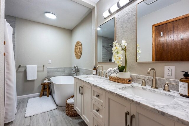 bathroom with vanity and a tub