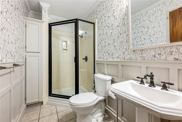 full bath featuring a wainscoted wall, ornamental molding, a stall shower, and wallpapered walls