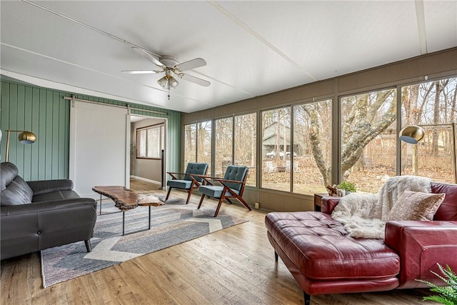 sunroom featuring a ceiling fan