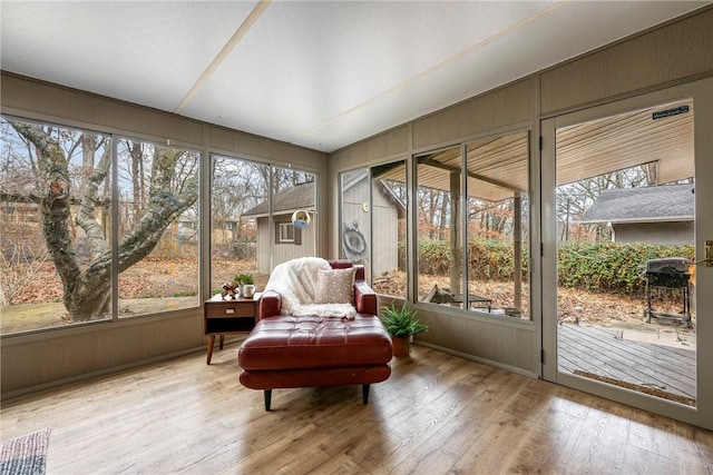 sunroom / solarium featuring lofted ceiling