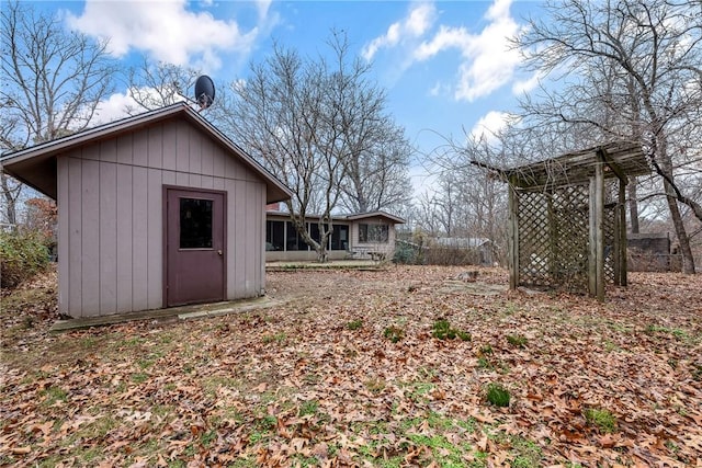 view of yard featuring a shed and a sunroom